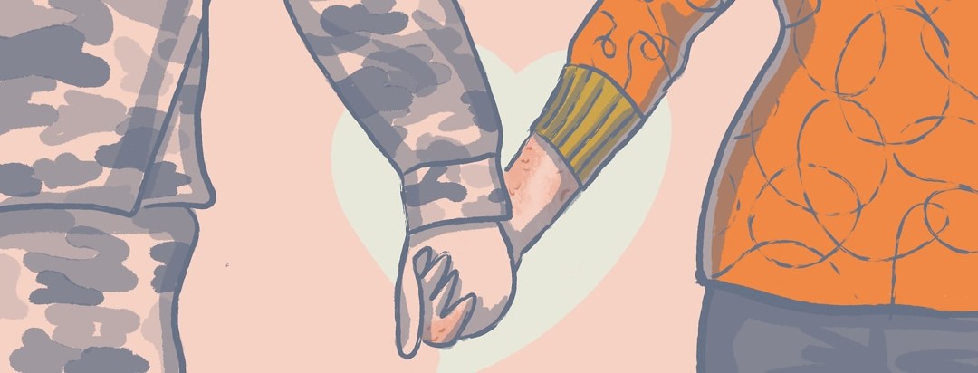 A man and a woman holding hands with a heart behind them. The woman has psoriasis on her hand and forearm and the man is wearing camo.