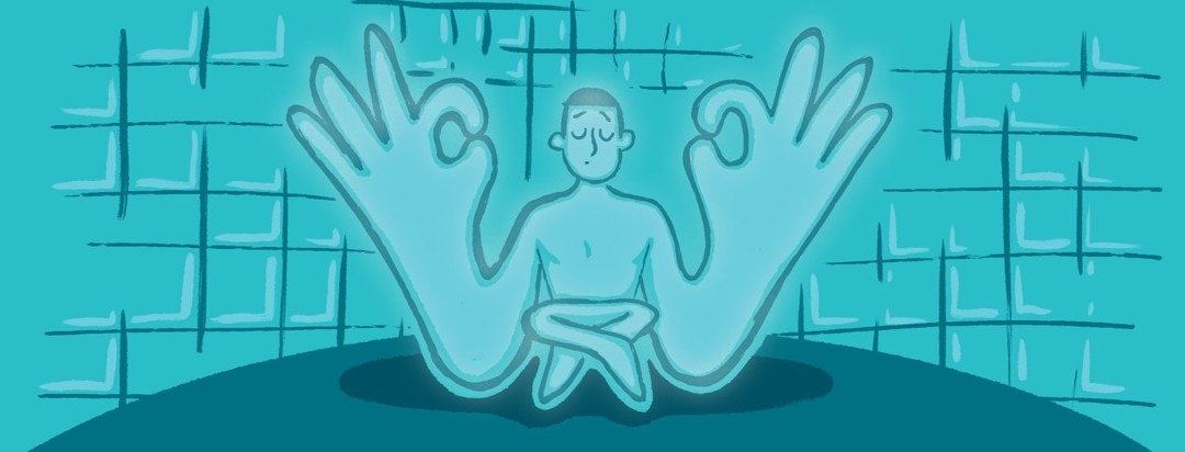 Figure in a meditative pose in a blue phototherapy chamber.