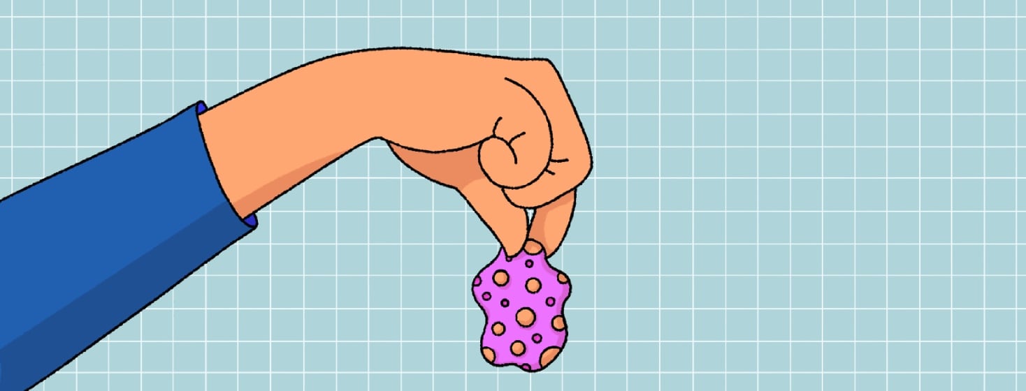 A hand holding a peeled plaque.