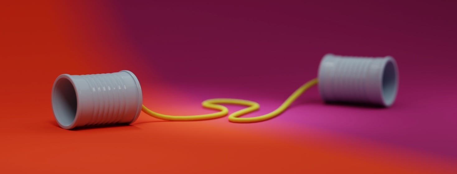 Two tin cans connected with a string. The left side of the image is orange, the right is purple.