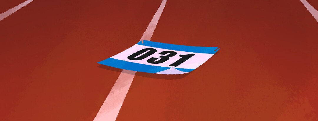 A runner's bib lying discarded on a track