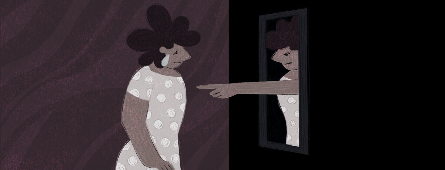 A woman looks in the mirror at a reflection of herself pointing an accusatory finger back at her